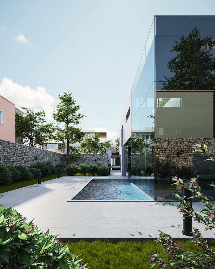 Elegant modern house with glass exterior and pool surrounded by lush greenery, under a clear sky.